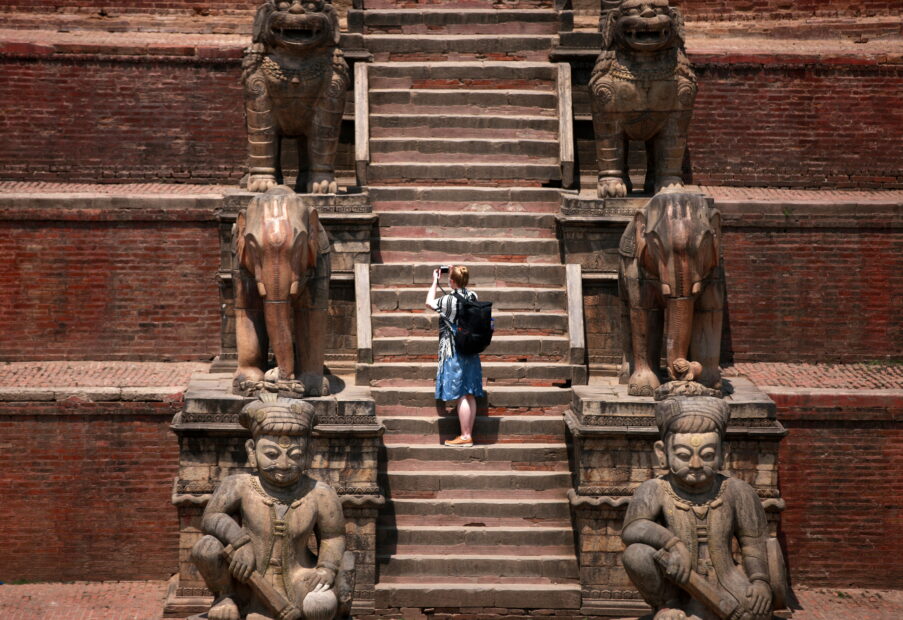 A foreign tourist takes pictures in front of the Nyatapola Temple in Bhaktapur